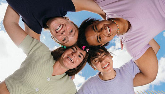 group shot of young people, clouds and sky in the background